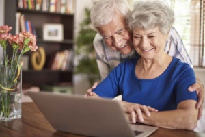 elderly couple working on a computer